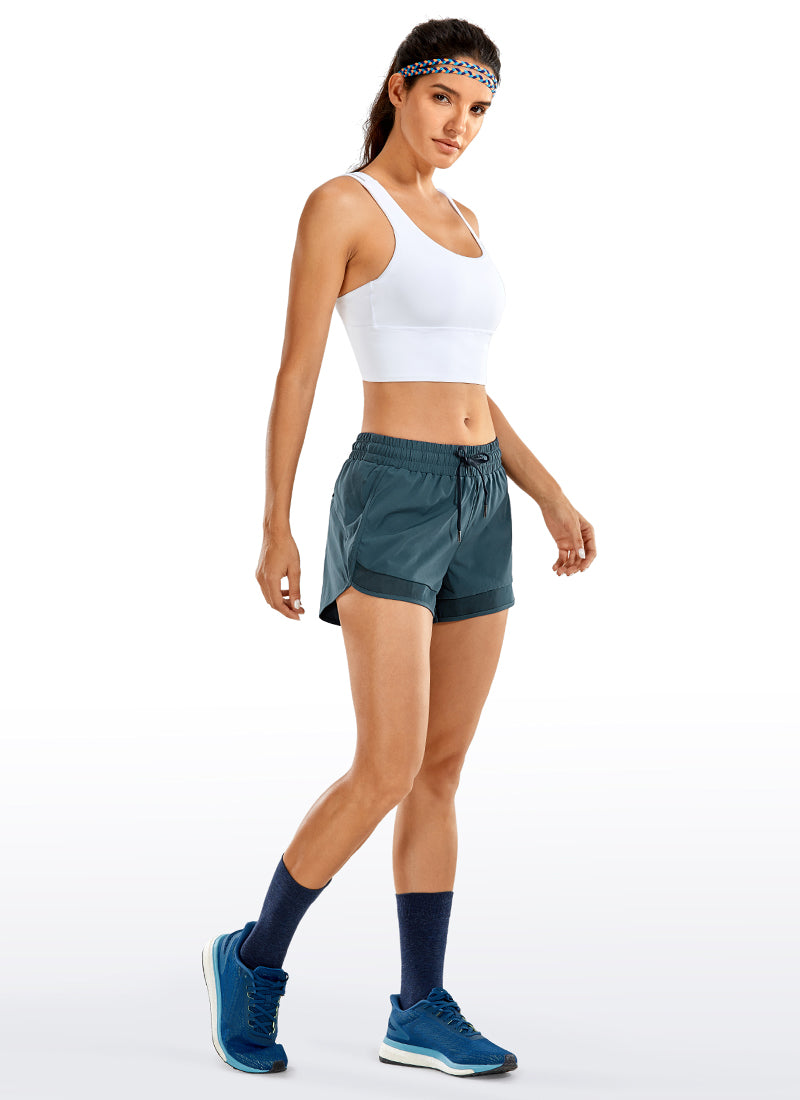 CRZ YOGA Women's Run Feathery-Fit Mid-Rise Lined Shorts Zip Pocket 3'' Stelindigo