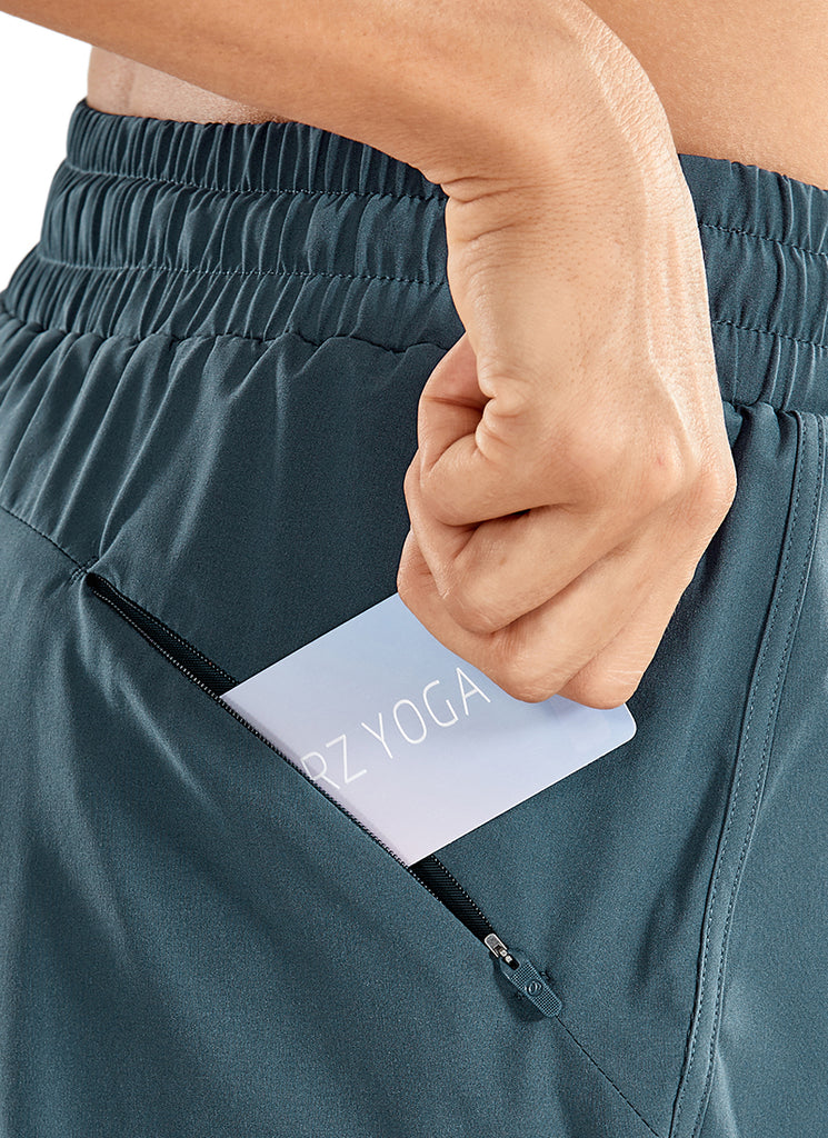 CRZ YOGA Women's Run Feathery-Fit Mid-Rise Lined Shorts Zip Pocket 3'' The dark purple